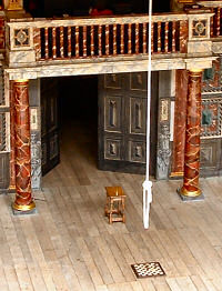 The Globe stage at the start of The Tempest. A rope hangs above a chessboard